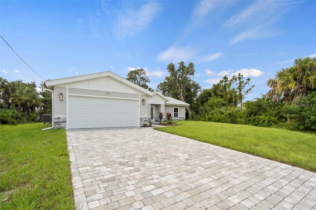 ranch-style home with a front lawn and a garage