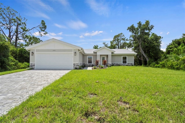 ranch-style house with a garage and a front lawn