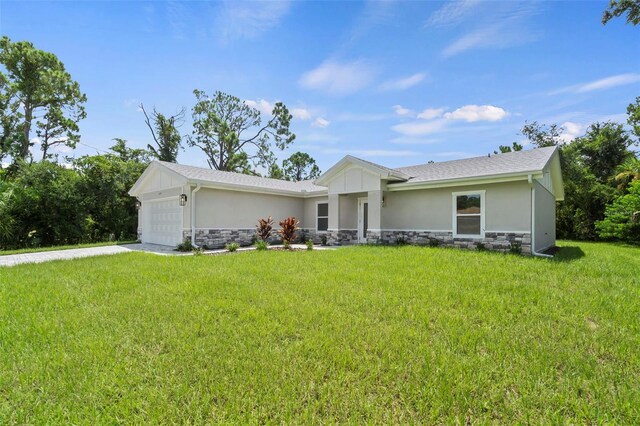 single story home with a garage and a front lawn