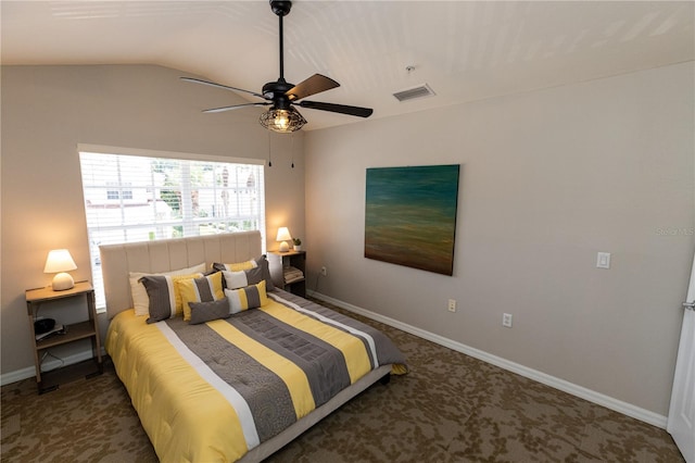 carpeted bedroom with ceiling fan and vaulted ceiling