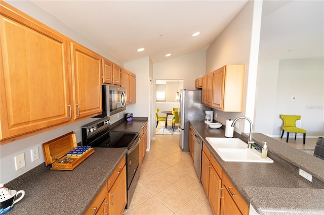 kitchen with sink, vaulted ceiling, light tile patterned floors, and stainless steel appliances