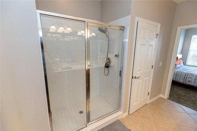 bathroom featuring tile patterned flooring and a shower with door