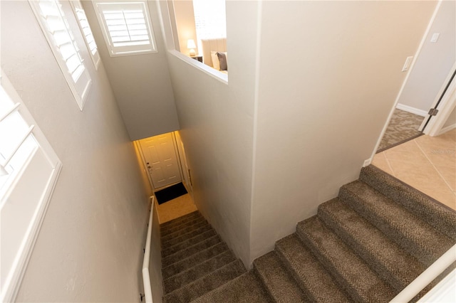 stairway with tile patterned floors