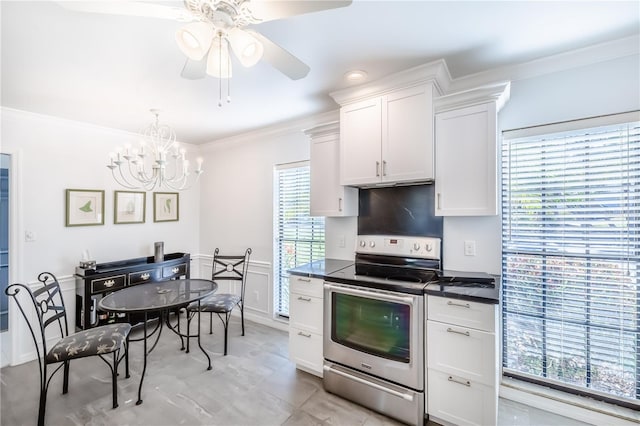 kitchen with ceiling fan with notable chandelier, crown molding, decorative backsplash, electric stove, and white cabinets