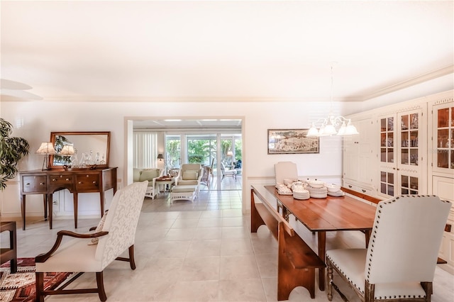 dining space with an inviting chandelier and light tile patterned flooring