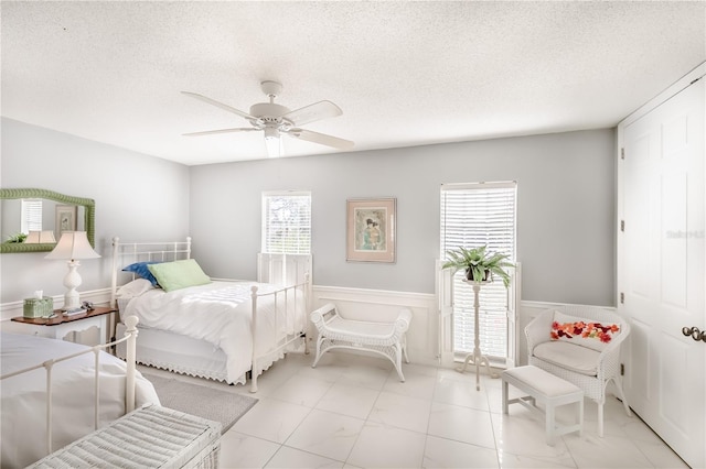 bedroom featuring a textured ceiling and ceiling fan