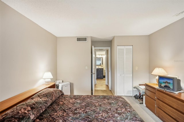 carpeted bedroom with a closet