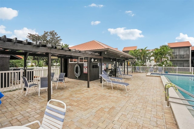 view of patio with a pergola and a community pool