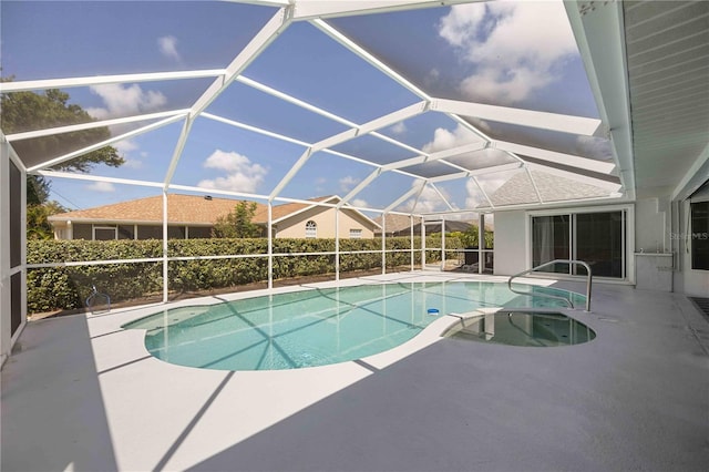 view of swimming pool featuring glass enclosure and a patio