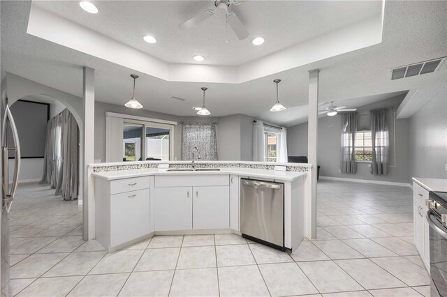 kitchen with a wealth of natural light, ceiling fan, sink, and stainless steel appliances