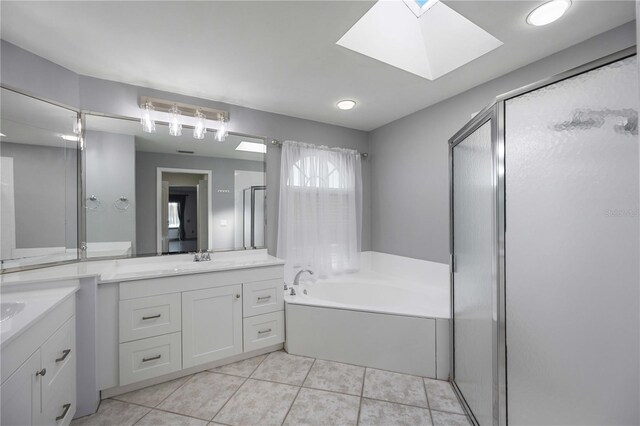 bathroom featuring vanity, tile patterned floors, plus walk in shower, and a skylight