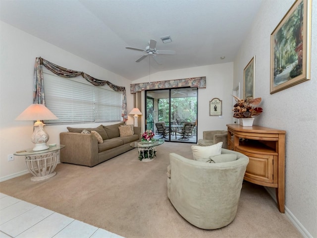 living room with ceiling fan, vaulted ceiling, and tile patterned floors