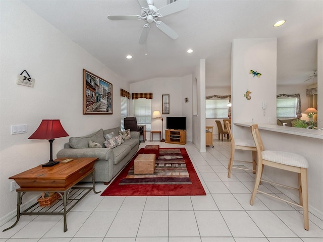 living room with a healthy amount of sunlight, light tile patterned floors, and ceiling fan