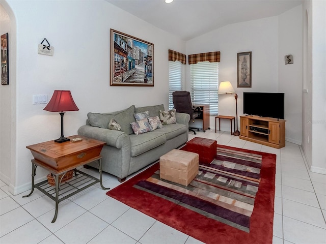 living room with light tile patterned floors and vaulted ceiling