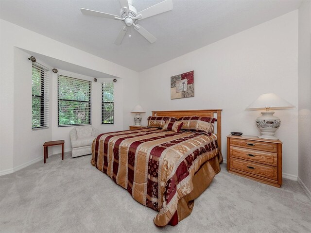 bedroom with ceiling fan and light colored carpet