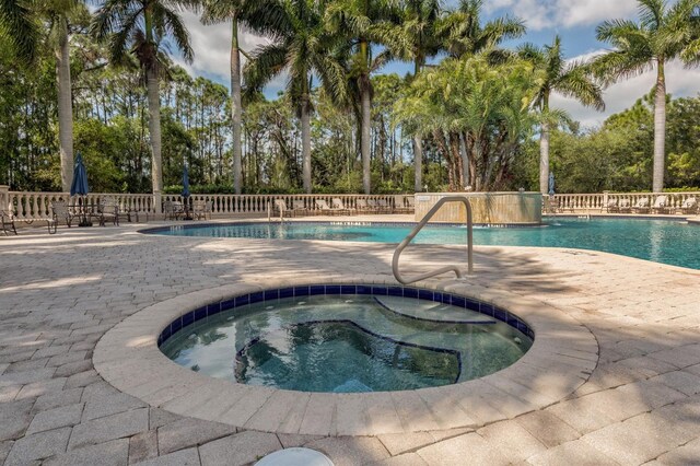 view of swimming pool featuring a community hot tub