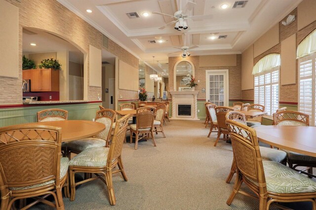 carpeted dining room featuring crown molding, coffered ceiling, beam ceiling, and ceiling fan