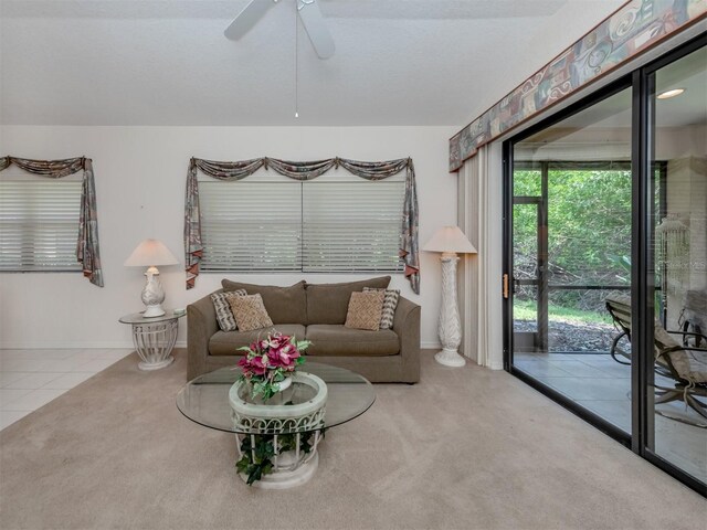 carpeted living room featuring ceiling fan