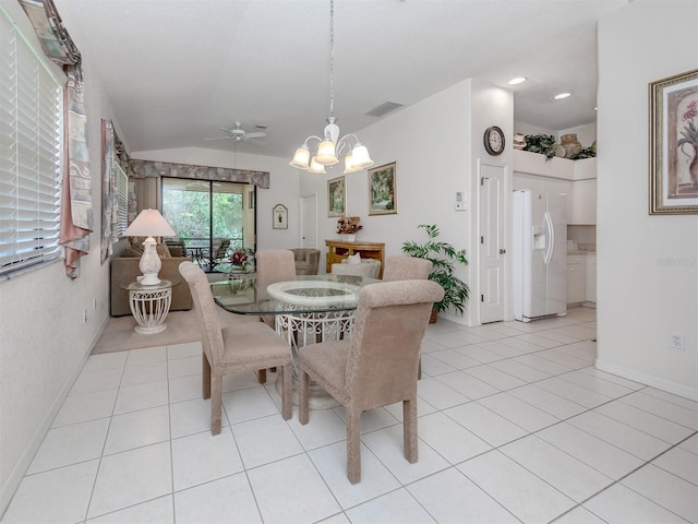 tiled dining area featuring lofted ceiling and ceiling fan with notable chandelier