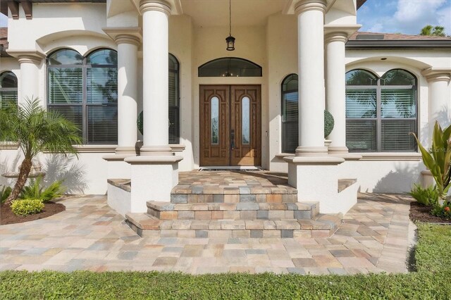 view of exterior entry featuring a porch