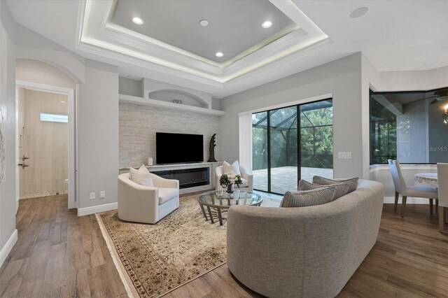 living room featuring a tray ceiling and hardwood / wood-style floors