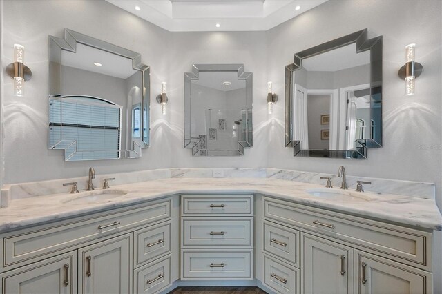 bathroom featuring walk in shower and vanity