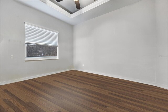 unfurnished room featuring a tray ceiling, ornamental molding, dark hardwood / wood-style floors, and ceiling fan