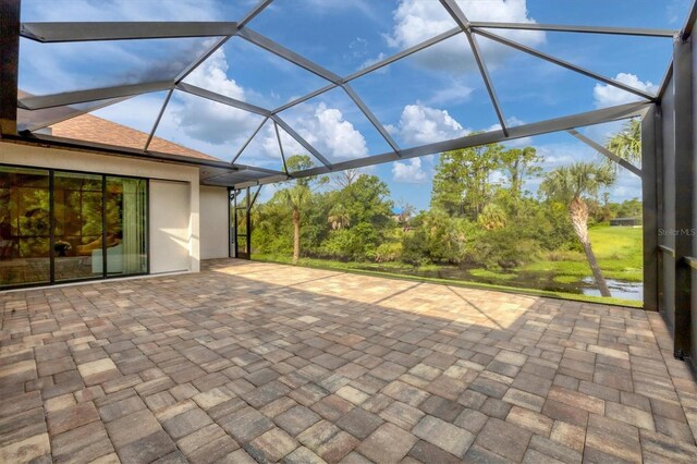 view of patio featuring glass enclosure