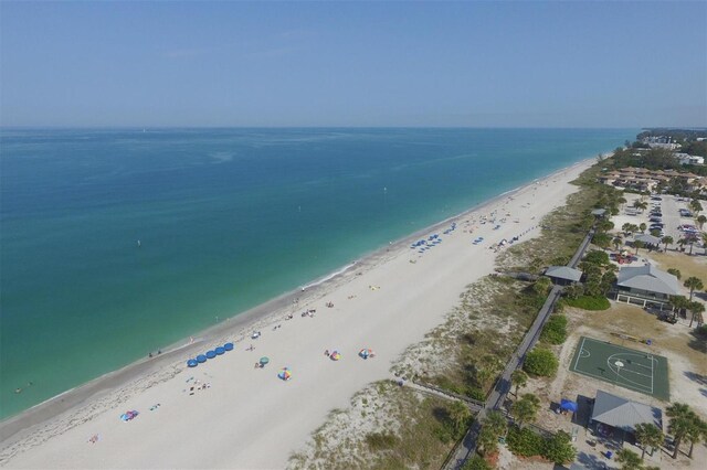 drone / aerial view featuring a view of the beach and a water view