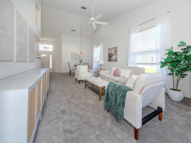 living room featuring light carpet, high vaulted ceiling, and ceiling fan