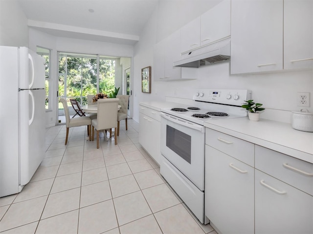 kitchen featuring white cabinets, white appliances, vaulted ceiling, and light tile patterned flooring