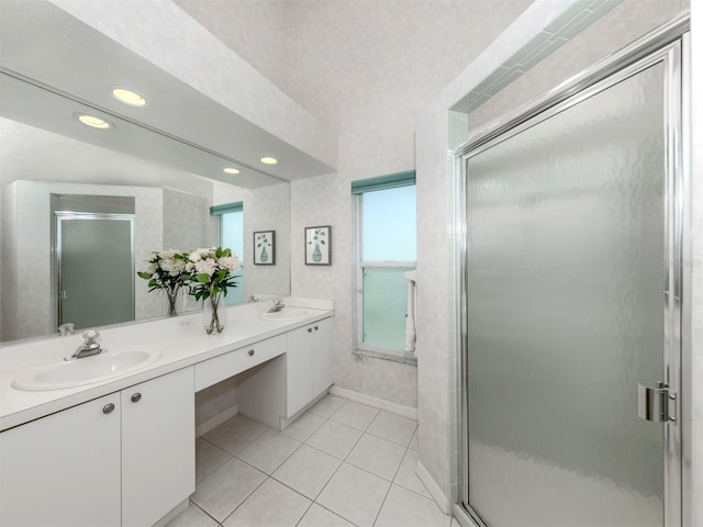 bathroom with tile patterned floors, a shower with door, and vanity