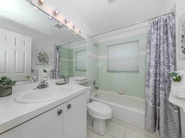 full bathroom featuring shower / bath combo with shower curtain, tile patterned flooring, vanity, and toilet