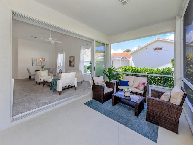 sunroom / solarium featuring ceiling fan