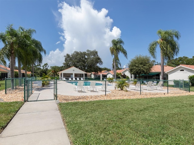 view of pool with a lawn