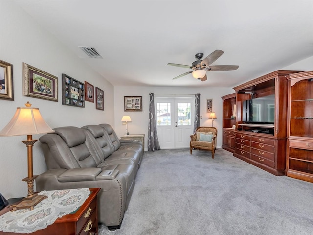 carpeted living room with ceiling fan