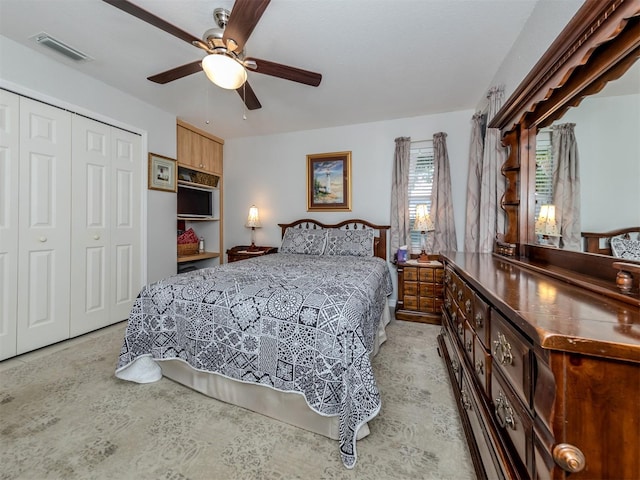 bedroom featuring ceiling fan and a closet