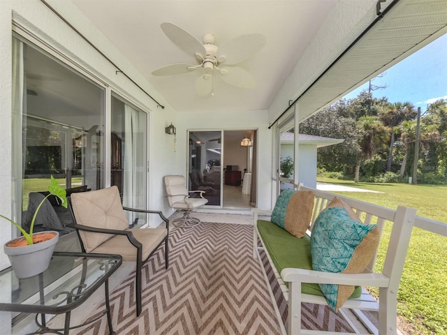 sunroom / solarium featuring ceiling fan