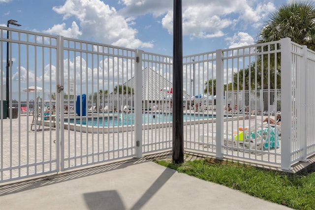 view of gate with a community pool