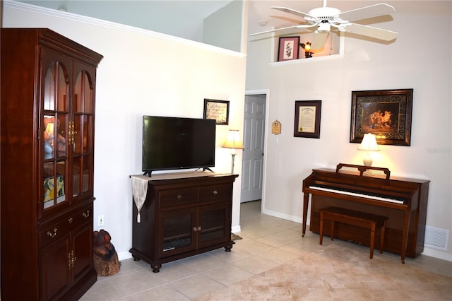 misc room featuring ceiling fan, light tile patterned flooring, crown molding, and high vaulted ceiling