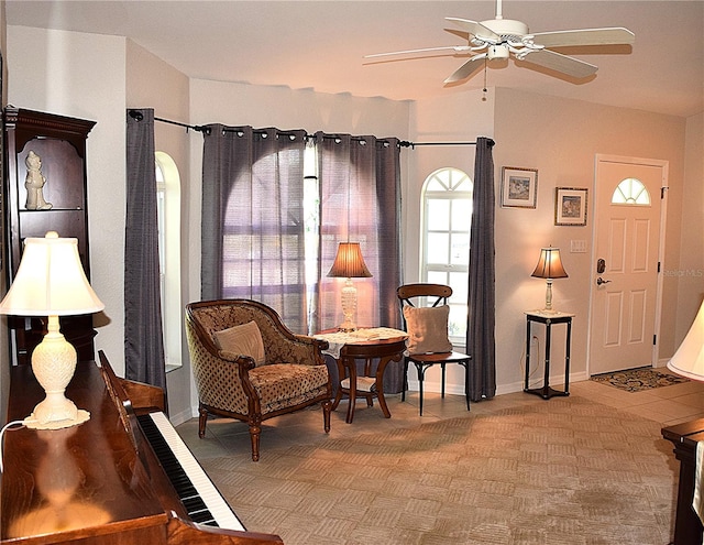 sitting room featuring light tile patterned flooring, lofted ceiling, and ceiling fan