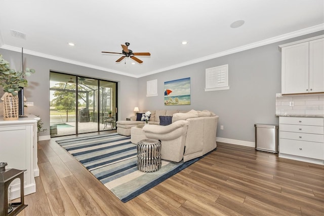 living room featuring ceiling fan, crown molding, and light wood-type flooring