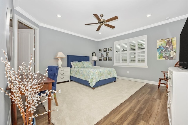 bedroom with hardwood / wood-style flooring, ceiling fan, and ornamental molding