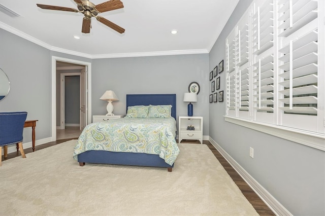 bedroom with ceiling fan, crown molding, and wood-type flooring