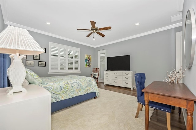 bedroom featuring ceiling fan, wood-type flooring, and ornamental molding