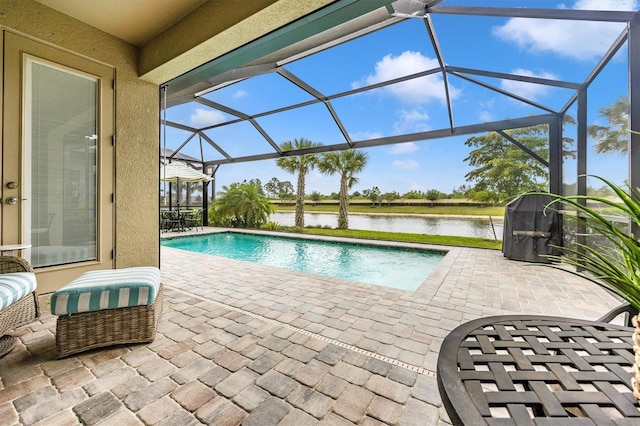 view of swimming pool with a water view, a patio area, and a lanai