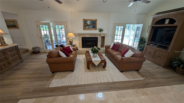 living room with a healthy amount of sunlight, ceiling fan, and french doors