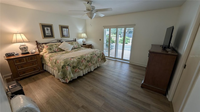 bedroom featuring ceiling fan, dark hardwood / wood-style floors, and access to outside