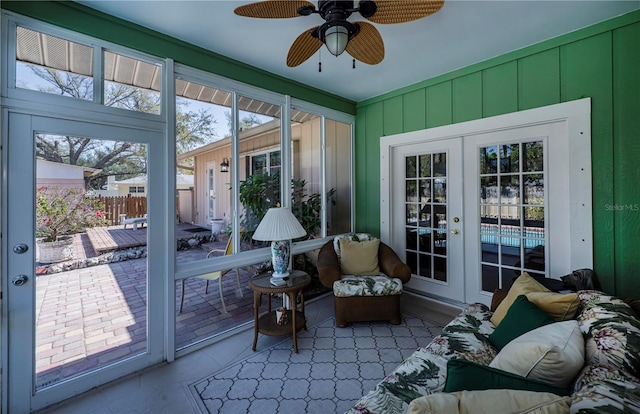 sunroom / solarium with a healthy amount of sunlight, ceiling fan, and french doors