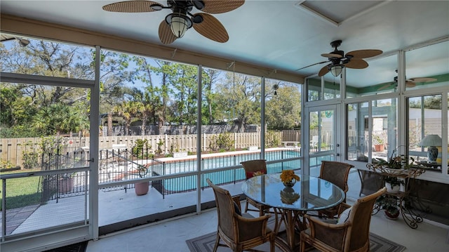 sunroom with a healthy amount of sunlight and ceiling fan